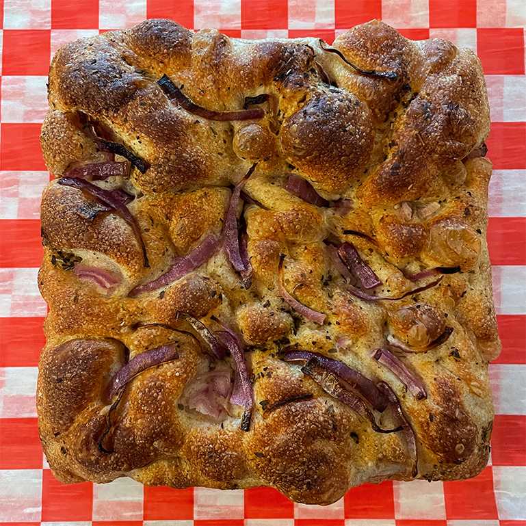 Baked focaccia with red onion seen from above