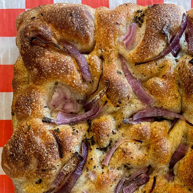 Close up of red onion and herb oil focaccia