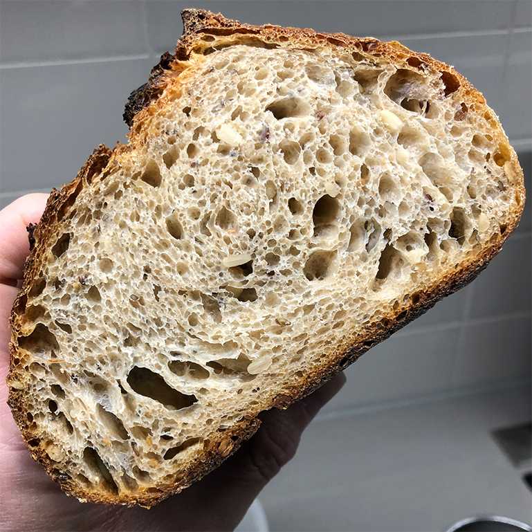 Sliced seeded sourdough bread center of loaf